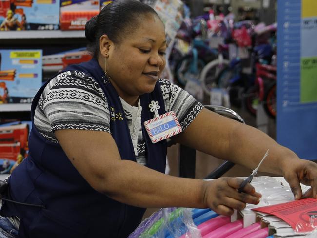 Balo Balogun labels items in preparation for a holiday sale at a Walmart Supercenter, Wednesday, Nov. 27, 2019, in Las Vegas. Black Friday once again kicks off the start of the holiday shopping season. But it will be the shortest season since 2013 because of Thanksgiving falling on the fourth Thursday in November, the latest possible date it can be. (AP Photo/John Locher)