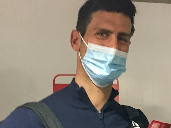 TOPSHOT - Serbia's tennis champion Novak Djokovic disembarks from a plane at the airport in Dubai on January 17, 2022, after losing a legal battle in Australia on January 16 over his coronavirus vaccination status. (Photo by AFP)