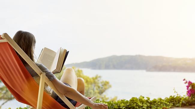 Woman reading book while relaxing on deck chair at back yardESCAPEAUGUST 30 2020NEWS & VIEWS OPINION