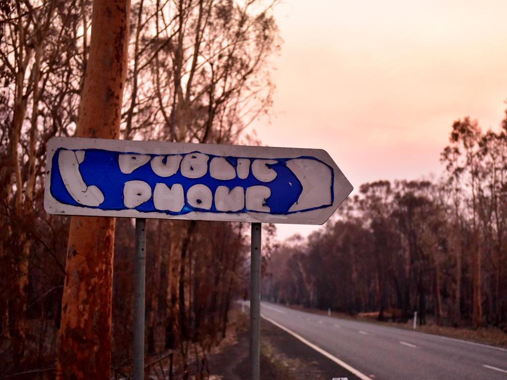 A melted road sign along Putty Rd, northwest of Sydney, where a huge fire is raging. Picture: WWW.MATRIXNEWS.COM.AU