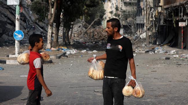 Gazans line up for hours and brave potential airstrikes to get bread. Picture: AFP