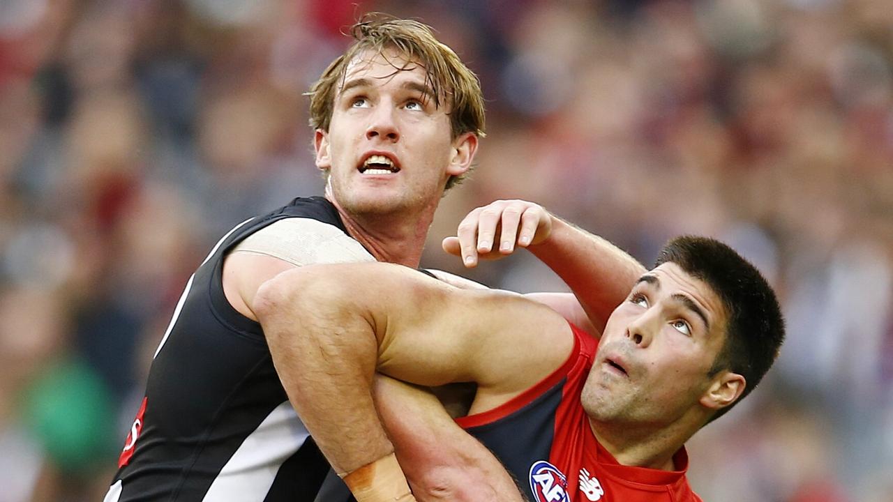 AFL Round 12 Melbourne v Collingwood at the MCG. chris Dawes battles 2 magpies . Pic: Michael Klein. Monday June 9, 2014.