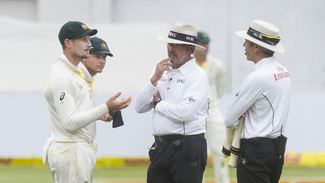 Umpires Nigel Llong and Richard Illingworth confront Australia's Cameron Bancroft today. Picture: Peter Heeger/Gallo Images/Getty