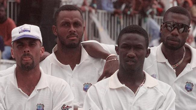 7Apr99 Players on the West Indies cricket team watch as Australia is presented with the Frank Worrell trophy after they won the fourth test match by 176 runs to retain the trophy on the fifth day of the fourth test match at the Antigua Recreation Ground in St. John's,  Antigua Wednesday, April 7,  1999. From left to right front are Jimmy Adams and  Wavell Heinds and rear Corey Collymore, Courtney Walsh, and Curtly Ambrose.  (AP Photo/Lynne Sladky)   f/l/Cricket