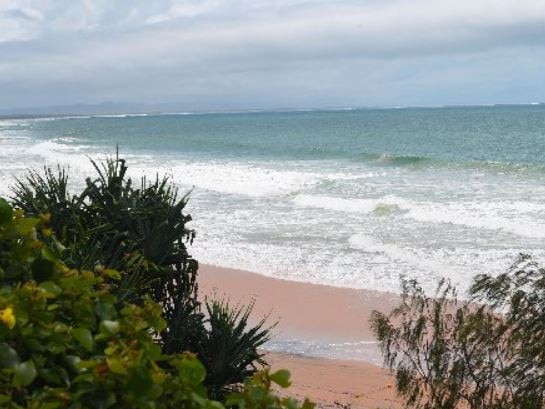 A woman is reportedly trapped on a cliff at Rainbow Beach.