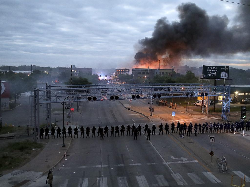 Law enforcement officers amassed along Lake Street in Minneapolis. Picture: David Joles/Star Tribune via AP.