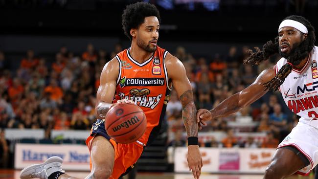 Taipans Melo Trimble gets past Hawks Jordair Jett during the Round 8 NBL match between Cairns Taipans and Illawarra Hawks at Cairns Convention Centre in Cairns, Friday, December 7, 2018. (AAP Image/Marc McCormack)