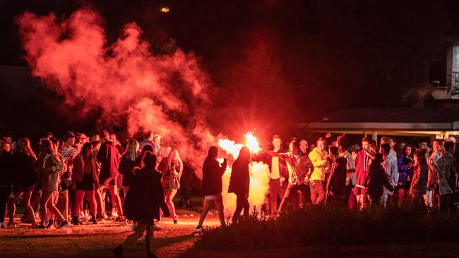 Brazen schoolies at Rye throw flares on Thursday night, despite police being in attendance. Picture: Jason Edwards