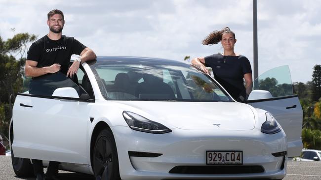 Varsity Lakes biz Outbound puts Teslas and other electric vehicles in commercial and residential complexes. Anyone staying at Mantra at the Sharks has access to the Tesla Model 3. Outbound CEO Luke Rust and Mantra guest service agent Sara Smith with the Tesla. Picture Glenn Hampson