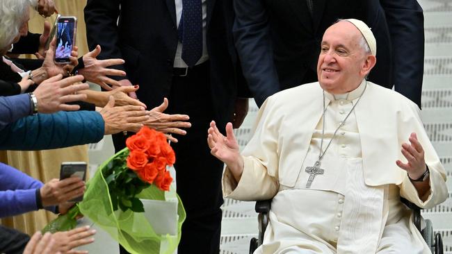 (FILES) In this file photo taken on December 28, 2022 Pope Francis salutes the pilgrims during the weekly general audience in Paul VI hall at the Vatican on December 28, 2022. - Pope Francis marks 10 years as head of the Catholic Church on Monday, hugely popular but facing internal dissent after a decade of reform, even if he has not questioned basic doctrine. (Photo by Filippo MONTEFORTE / AFP)