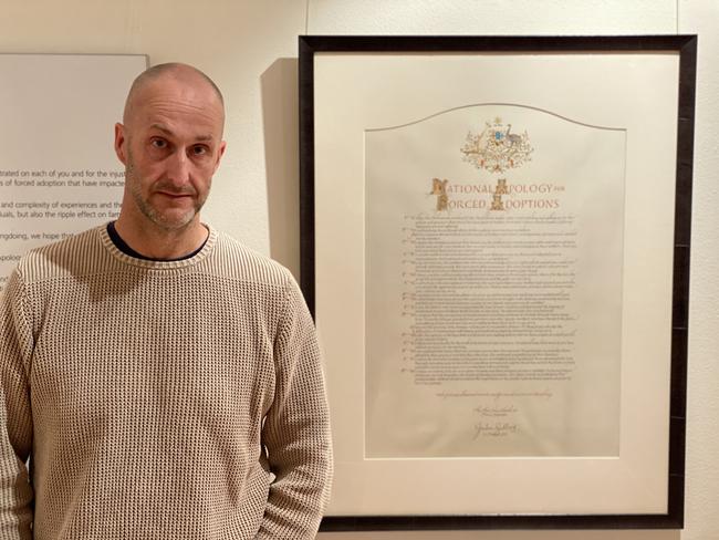 Abe Maddison with the National Apology for Forced Adoptions, at the Without Consent exhibition in Adelaide, in 2020, after absorbing the stories of mothers and children torn apart by forced adoption.