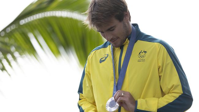 TEAHUPO'O, FRENCH POLYNESIA - AUGUST 05: Silver Medalist Jack Robinson of Team Australia looks at his medal on the podium during the Men's surfing medal ceremony on day nine of the Olympic Games Paris 2024 on August 05, 2024 in Teahupo'o, French Polynesia. (Photo by Sean M. Haffey/Getty Images)