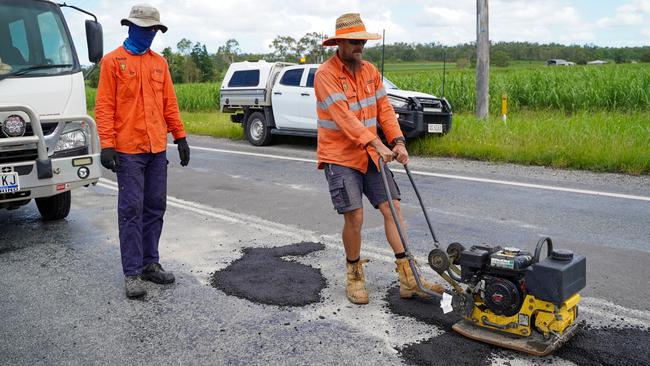 Road Tek crew members Andrew McGlashan and Chris field working to patch the Bruce Highway near Calen on Thursday, January 19, 2023, following the rainfall event in North Queensland. Picture: Heidi Petith