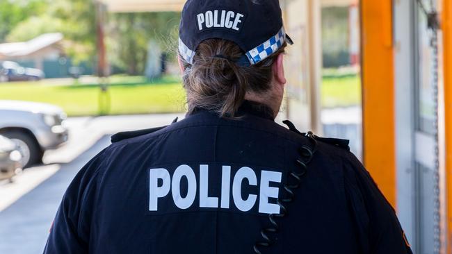 A woman has spat into the face of a female police officer as she was being taken into protective custody overnight