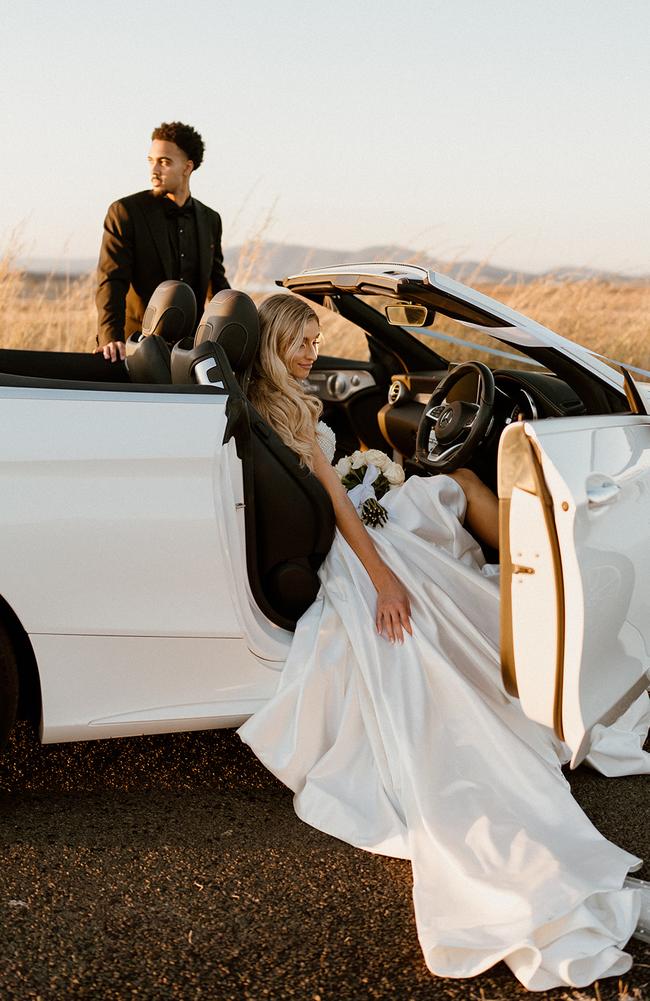 Miela and Josh in a convertible.