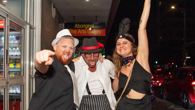 A colourful trio enjoying NYE on Mitchell Street. Picture: Pema Tamang Pakhrin