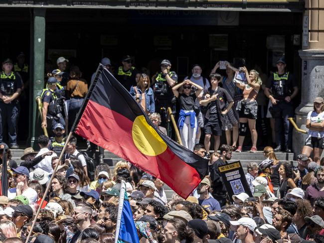 Invasion Day protest. Melbourne CBD. Australia Day. Protesters march through the CBD before rallying at Flinders Street Station. Picture: Jake Nowakowski