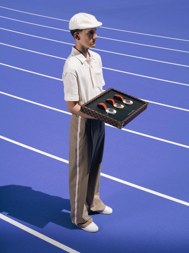 An Olympic medal bearer with the Louis Vuitton trays.