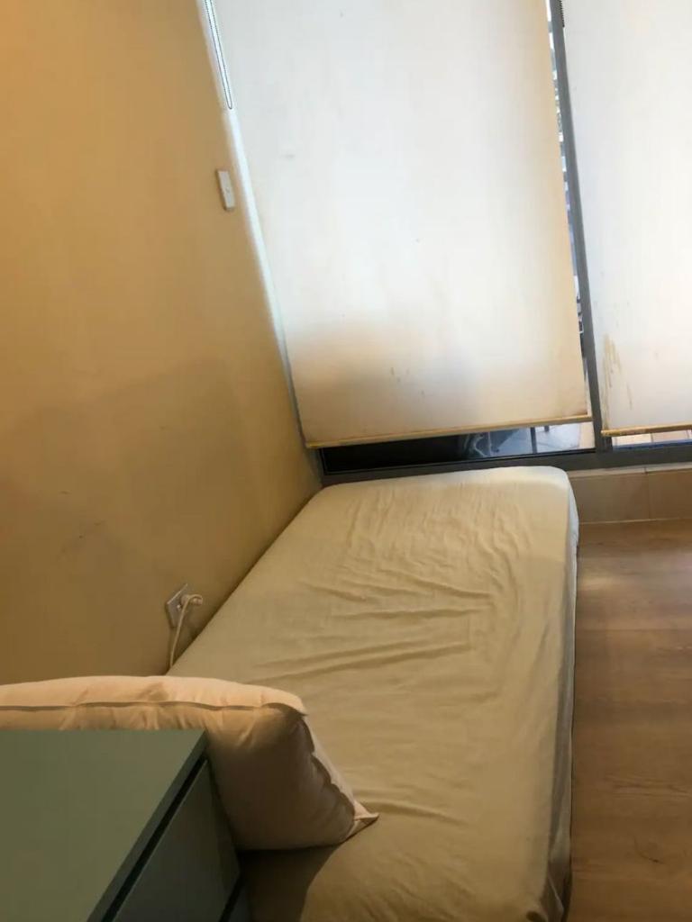 The room contains a mattress on the floor and a makeshift wardrobe. Picture: Airbnb