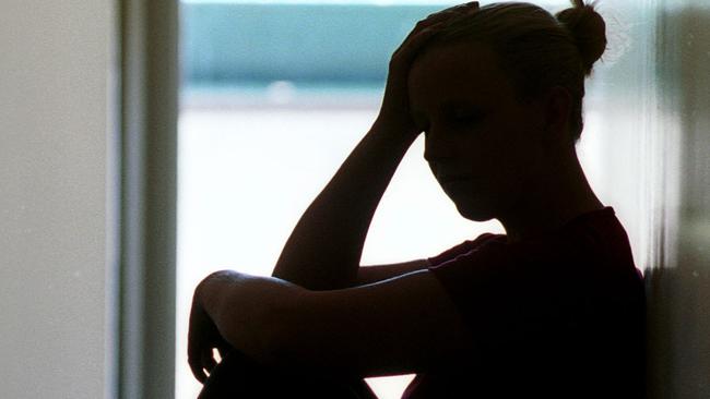 21 Dec 2001 Silhouette of young woman seated in doorway, date rape victim in Adelaide. Sexual Assault crime sa sex generic