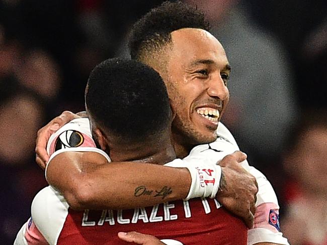 Arsenal's Gabonese striker Pierre-Emerick Aubameyang (R) celebrates with Arsenal's French striker Alexandre Lacazette after scoring their third goal during the UEFA Europa League semi final, first leg, football match between Arsenal and Valencia at the Emirates Stadium in London on May 2, 2019. - Arsenal won the game 3-1. (Photo by Glyn KIRK / AFP)