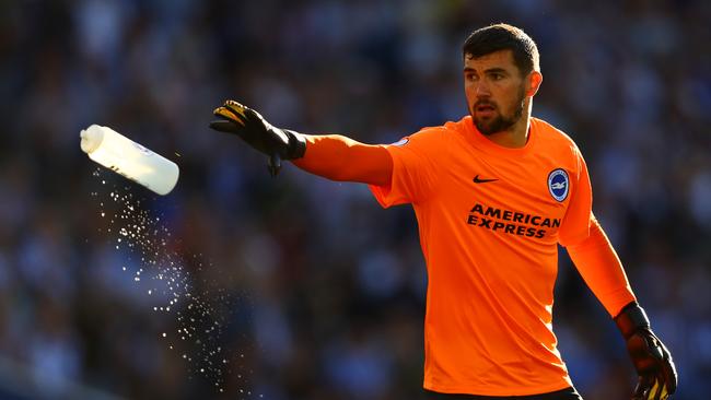 Mathew Ryan of Brighton and Hove Albion throws a water bottle.