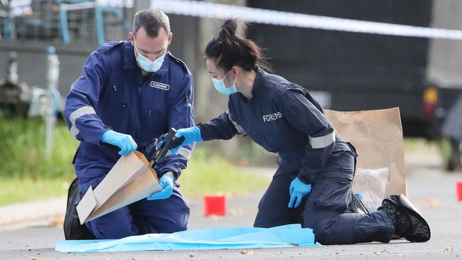 Police at the scene of a fatal shooting in Caroline Springs. Pic of police picking up the gun. Friday, January 10. 2024. Picture: David Crosling
