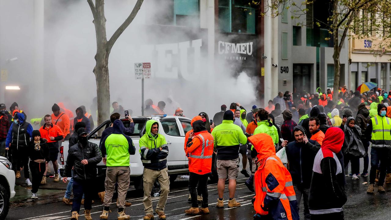 Crowds outside the CFMEU building, where flares were lit and objects thrown. Picture: Tim Carrafa