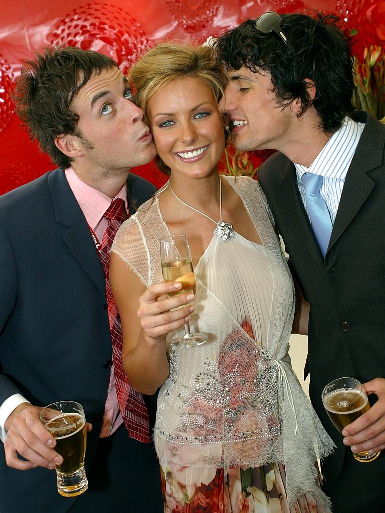 2004: Hamish Blake and Andy Lee kiss Jennifer Hawkins at Derby Day, Flemington. Picture: News Corp