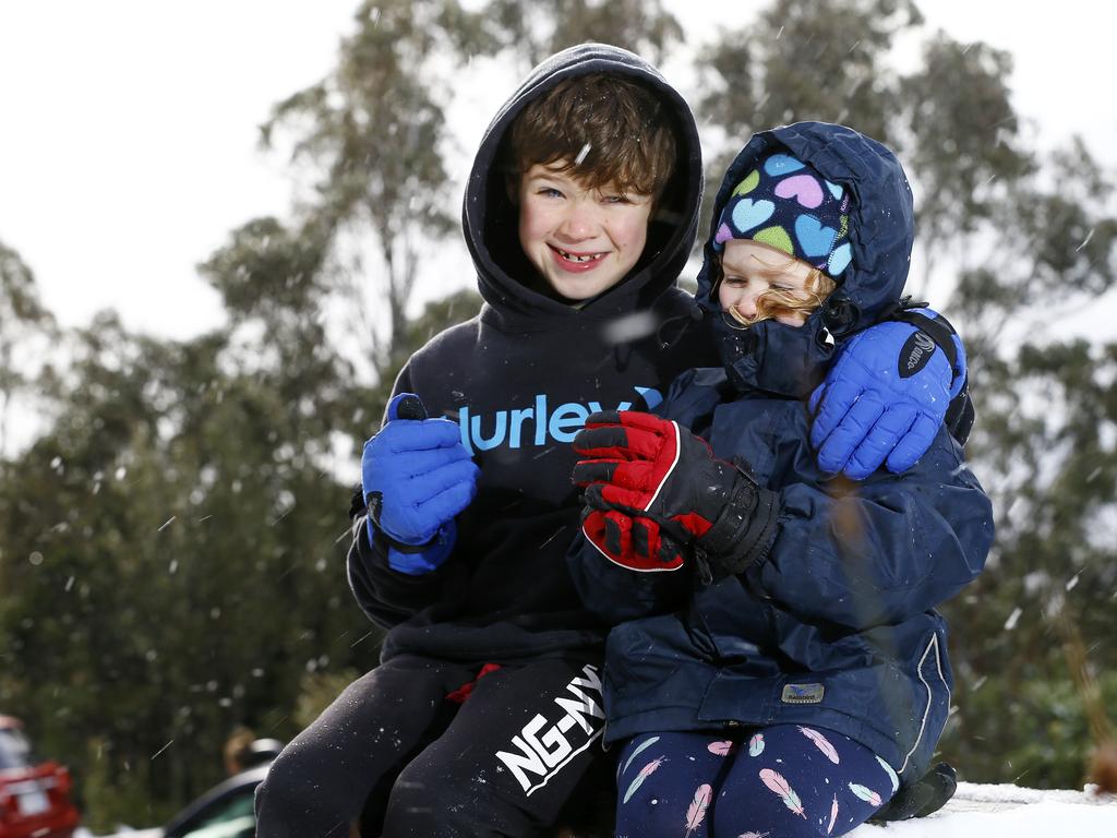 Strong Southerly winds have brought snow to Kunanyi / Mount Wellington over night. Pictured above the Springs is (L-R) Wesley, 8, and Wren Smith, 4, of Neika. Picture: MATT THOMPSON