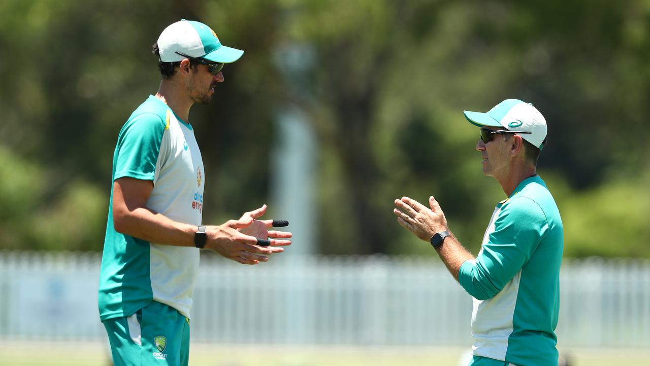 Mitchell Starc chats to coach Justin Langer. Picture: Chris Hyde/Getty