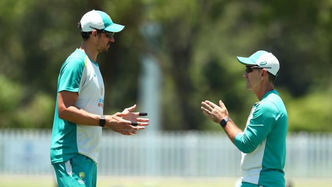 Mitchell Starc chats to coach Justin Langer. Picture: Chris Hyde/Getty