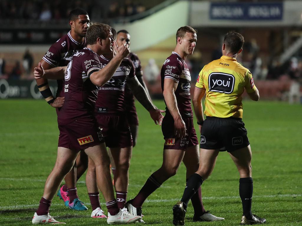 Manly's Daly Cherry-Evans with referee Grant Atkins at full time.