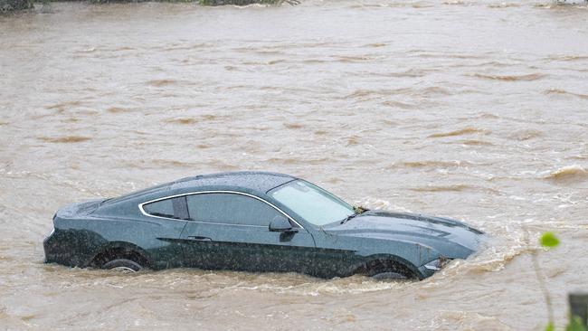 A submerged car near the shopping centre. Picture: Richard Walker