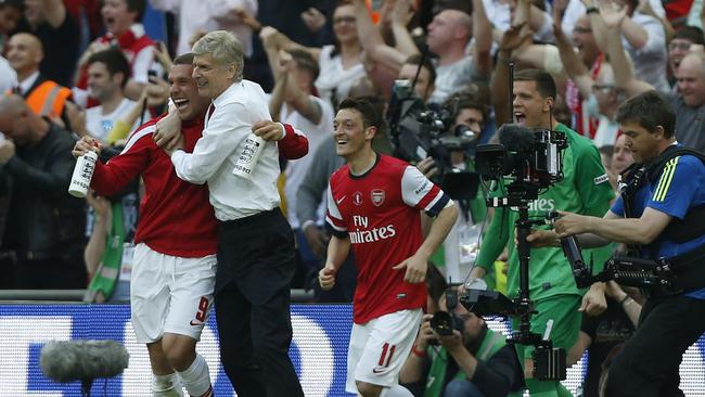 Arsenal's manager Arsene Wenger with Podolski.