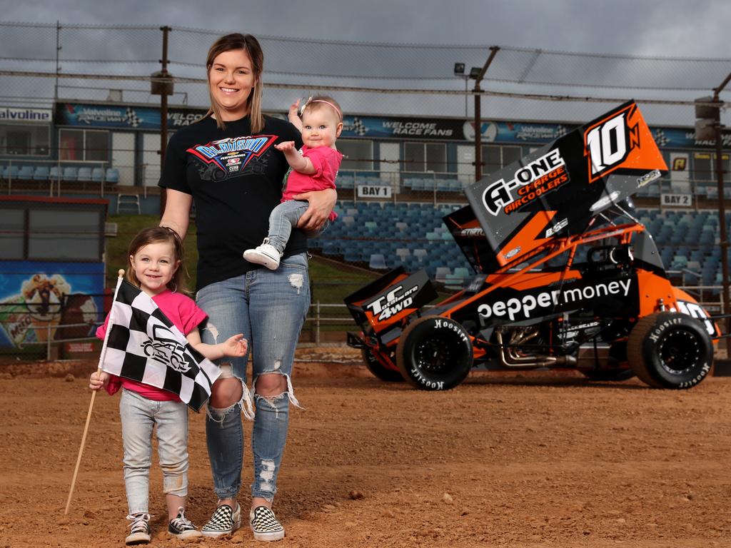 Sprint car driver Mikaela Darcy and her daughters, Callie 3 &amp; Addie (Addison) 8 months at the Sydney Speedway in Granville. Picture: Jonathan Ng