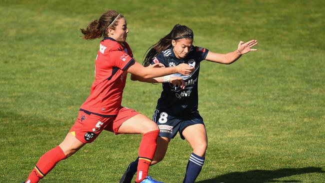 Jenna McCormick of Adelaide United and Angela Beard of the Victory compete for the ball. (Photo by Quinn Rooney/Getty Images)