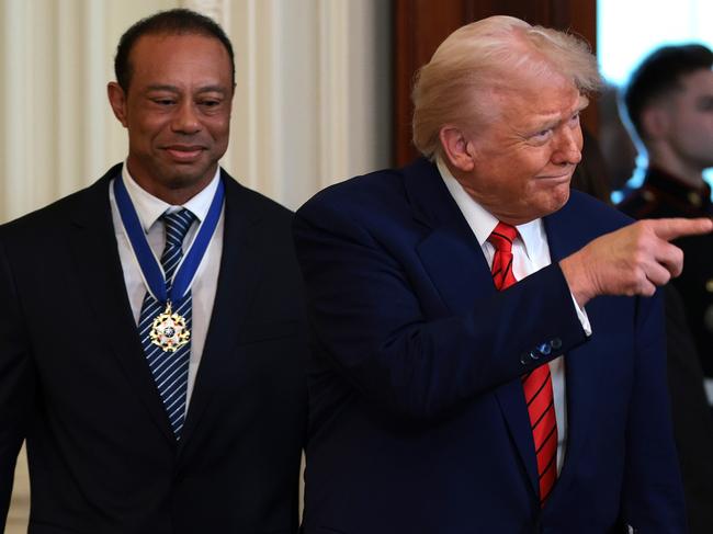 WASHINGTON, DC - FEBRUARY 20: U.S. President Donald Trump and golf legend Tiger Woods arrive for a reception honoring Black History Month in the East Room of the White House on February 20, 2025 in Washington, DC. The Black History Month celebration comes as Trump has signed a series of executive orders ending federal diversity, equity and inclusion (DEI) programs and cutting funding to schools and Universities that do not cut DEI programs. (Photo by Win McNamee/Getty Images)