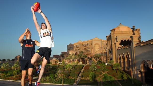 Jordan Russell and Bryce Gibbs have a kick outside the Emirates Palace Hotel.