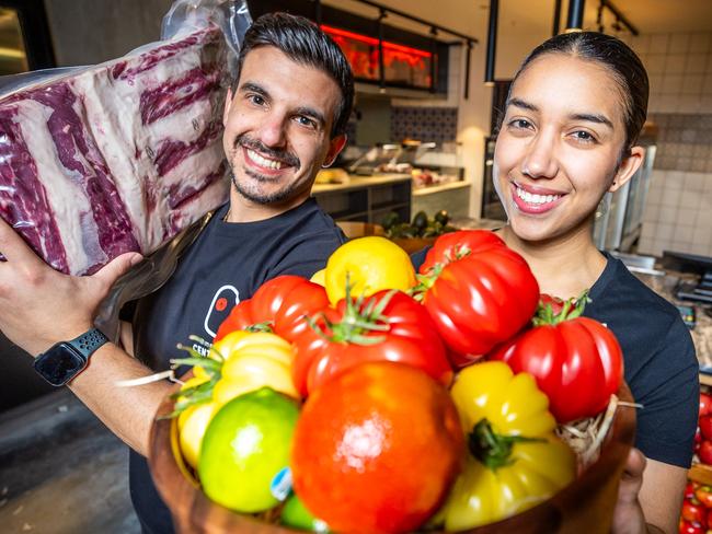 Nikos Chatzopolous and Maria Paula Gonzalez get set for the opening of Il Mercato Italian mega market. Picture: Jake Nowakowski