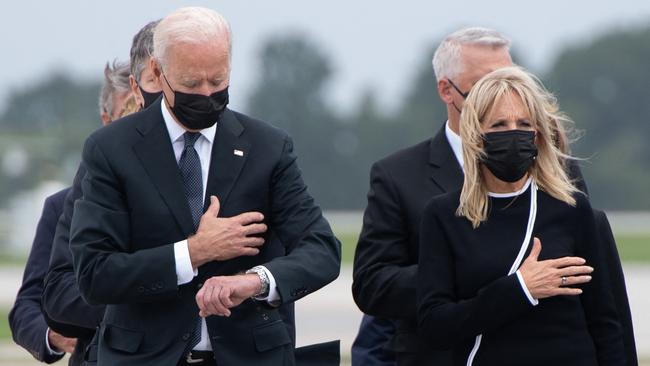 US President Joe Biden appears to check his watch as as the remains of American soldiers are removed from a military aircraft at Dover Air Force Base. Picture: AFP