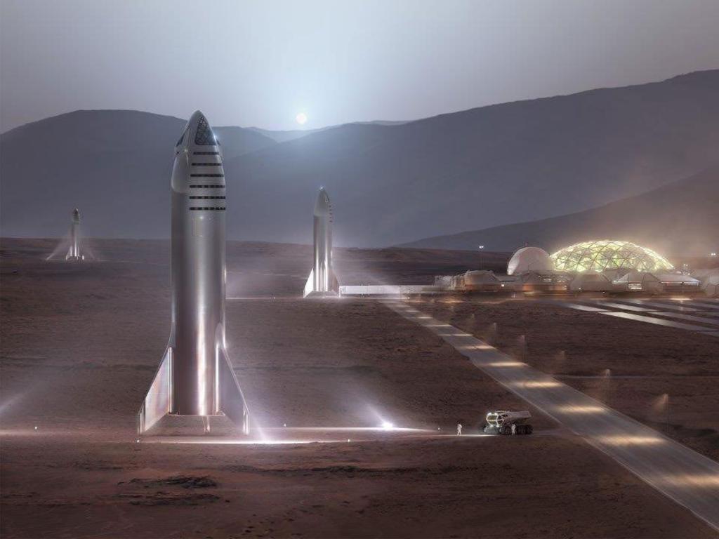 A SpaceX promotional image of its Starship rockets stationed alongside a domed Mars colony habitat. Picture: SpaceX