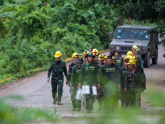 Thai soldiers walk out from the Tham Luang cave area as operations continue. Picture: AFP