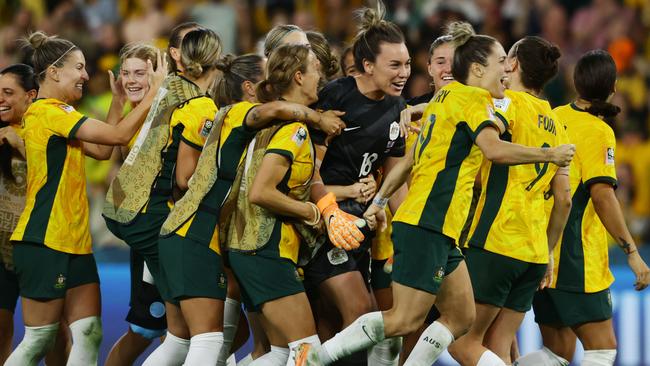 Matildas players celebrate winning the World Cup quarter-final match against France. Picture Lachie Millard