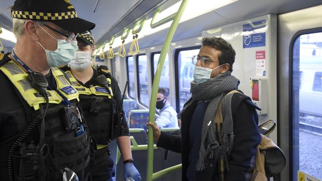 Police and PSOs enforcing mask-wearing on Monday. Picture: Andrew Henshaw