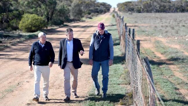 Orroroo farmer Geoff Power, Primary Industries Minister Tim Whetstone and Craig Trowbridge, chairman of the Penong Dog Fence Board, look over the Dog Fence west of Ceduna. Picture: Tricia Watkinson