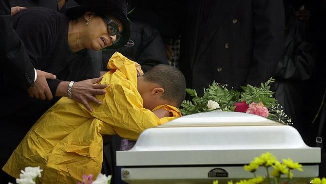 Anna Jager holds her grandson Kevin Villa (8) as he cries over his mother's casket during her funeral at in New York.