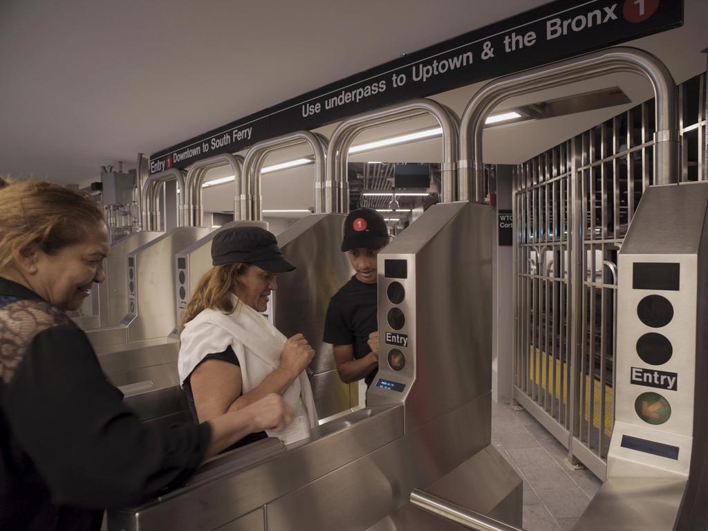 Passengers use a card to enter the newly-opened WTC Cortlandt subway station in New York. Some 5.5 million commuters use the system every day.
