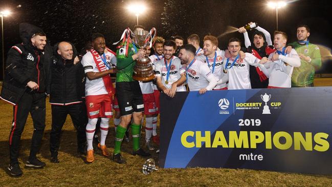 Hume City players and coaches celebrate their Dockerty Cup victory over Melbourne Knights. Picture: Mark Avellino, Football Victoria