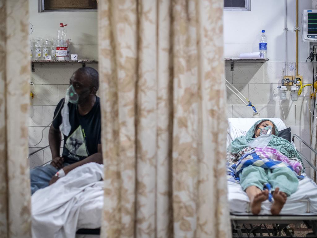 Patients who contracted the coronavirus rest while connected to oxygen supplies inside the emergency ward of a COVID-19 hospital in New Delhi. Picture: Rebecca Conway